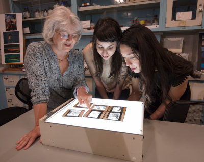 image of 3 women looking at lantern slides